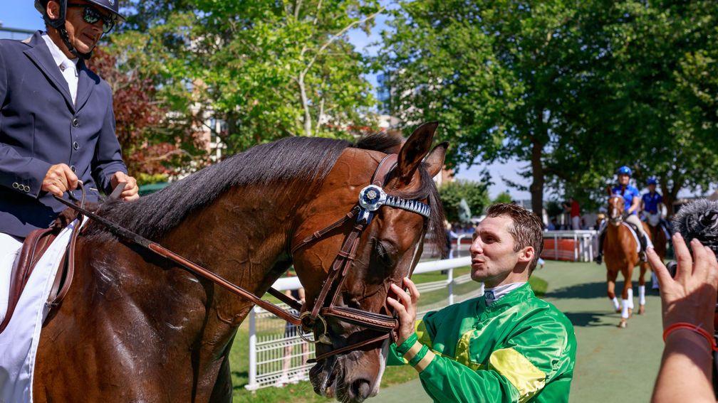 Friends reunited: Jockey Stephane Pasquier greets Signs Of Blessing and dressage rider Robert Danloux during the Au Dela Des Pistes parade of champions at Deauville