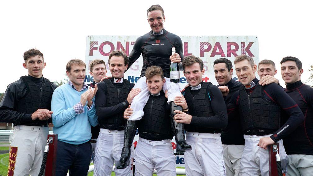 Andrew Tinkler (centre on the shoulders on Jamie Moore) is congratulated by his fellow jockeys after riding his last race at Fontwell