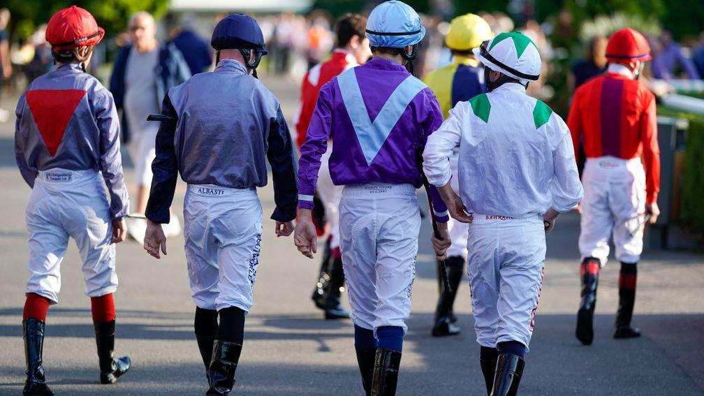 SUNBURY, ENGLAND - AUGUST 25: A general view as jockeys leave the weighing room and make their way to the parade ring at Kempton Park Racecourse on August 25, 2021 in Sunbury, England. (Photo by Alan Crowhurst/Getty Images)