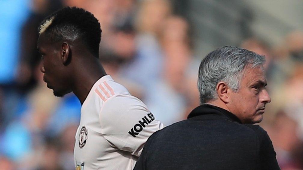 Paul Pogba walks past Jose Mourinho after being substituted