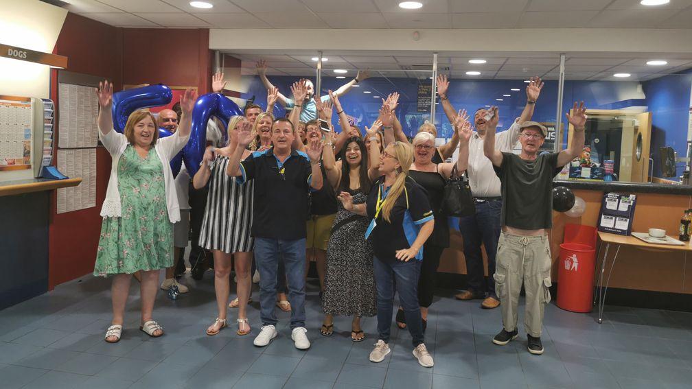 Robert Gorvett celebrates with friends at the betting shop he has managed for nine years