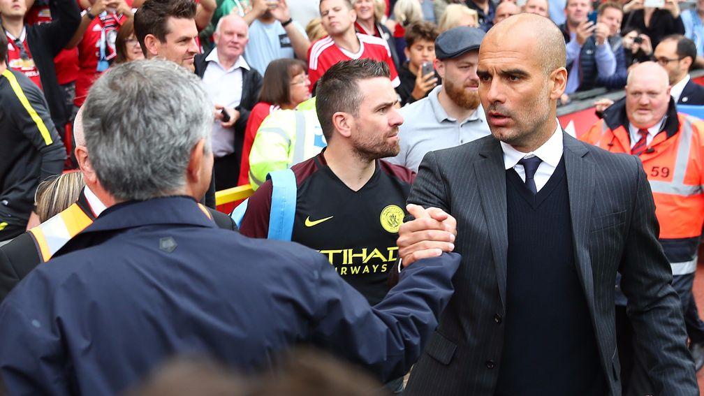 Manchester United manager Jose Mourinho shakes hands with  Manchester City manager Pep Guardiola