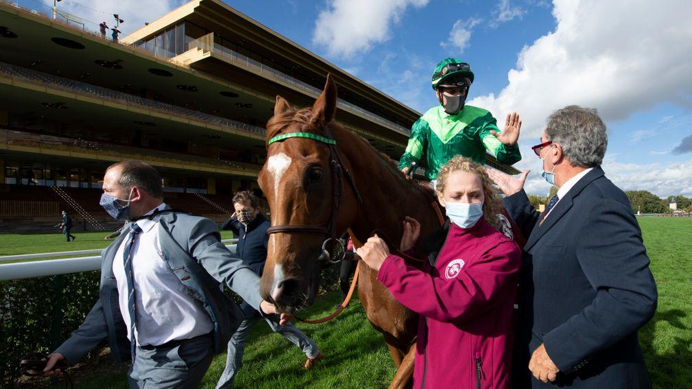 Sottsass and Cristian Demuro are led in after winning the 2020 Prix de l'Arc de Triomphe