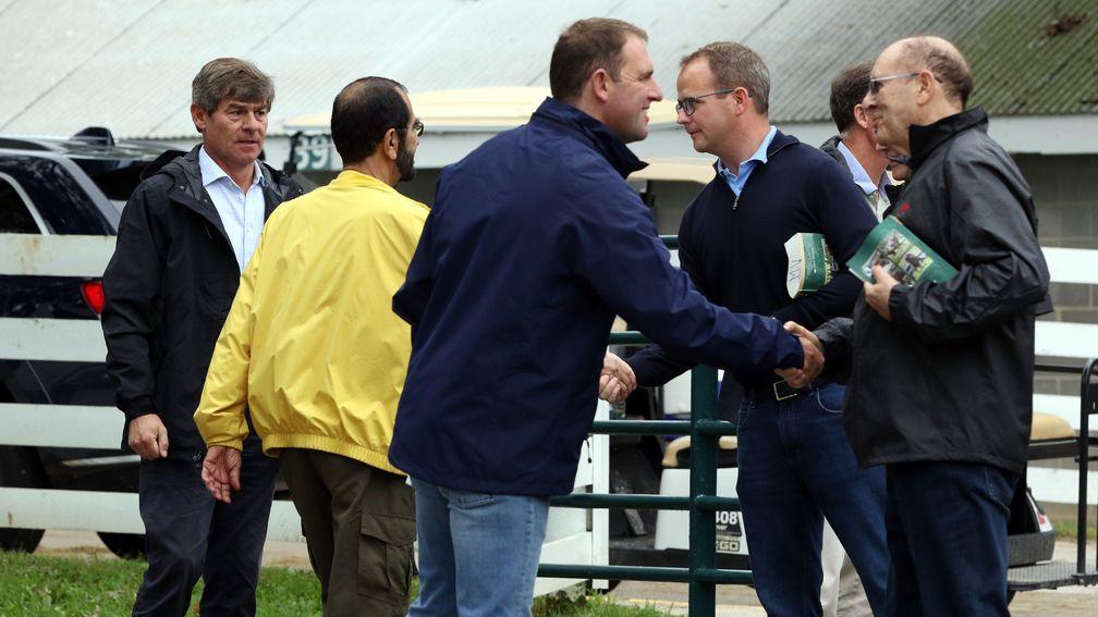 Good relations between Godolphin and Coolmore as Charlie Appleby (blue jacket) and Michael Tabor (right) shake hands, as do Sheikh Mohammed (yellow jacket) and MV Magnier (second right), as Simon Crisford (left) looks on