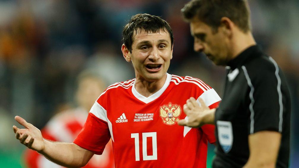Russia's Alan Dzagoev argues with the referee