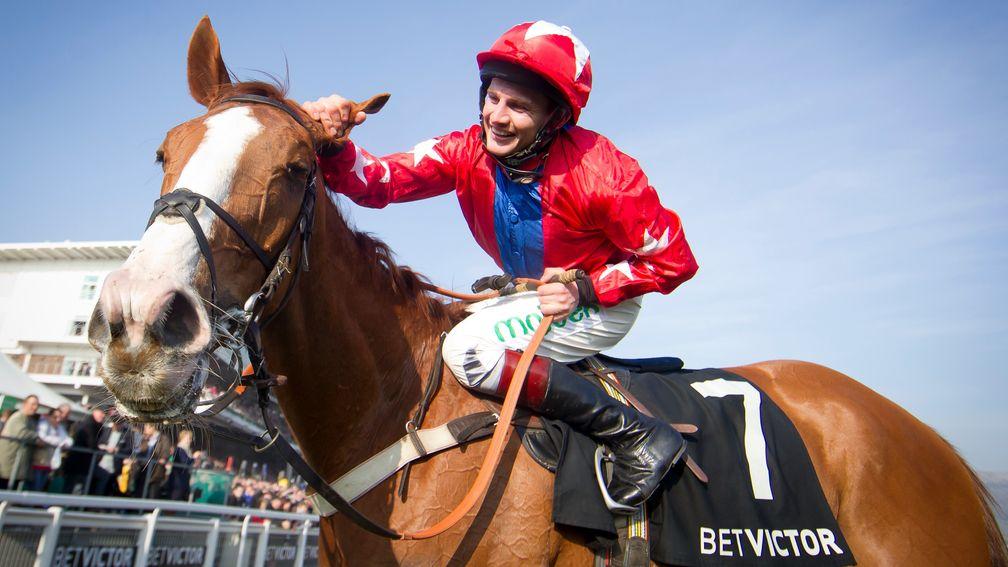 Jamie Moore pats Sire De Grugy affectionately after winning the 2014 Champion Chase at the Cheltenham Festival