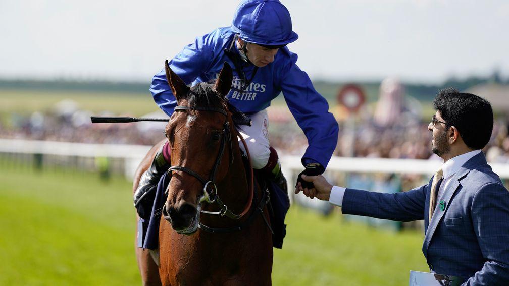 Oisin Murphy celebrates with trainer Saeed bin Suroor after riding Mawj to win the 1,000 Guineas