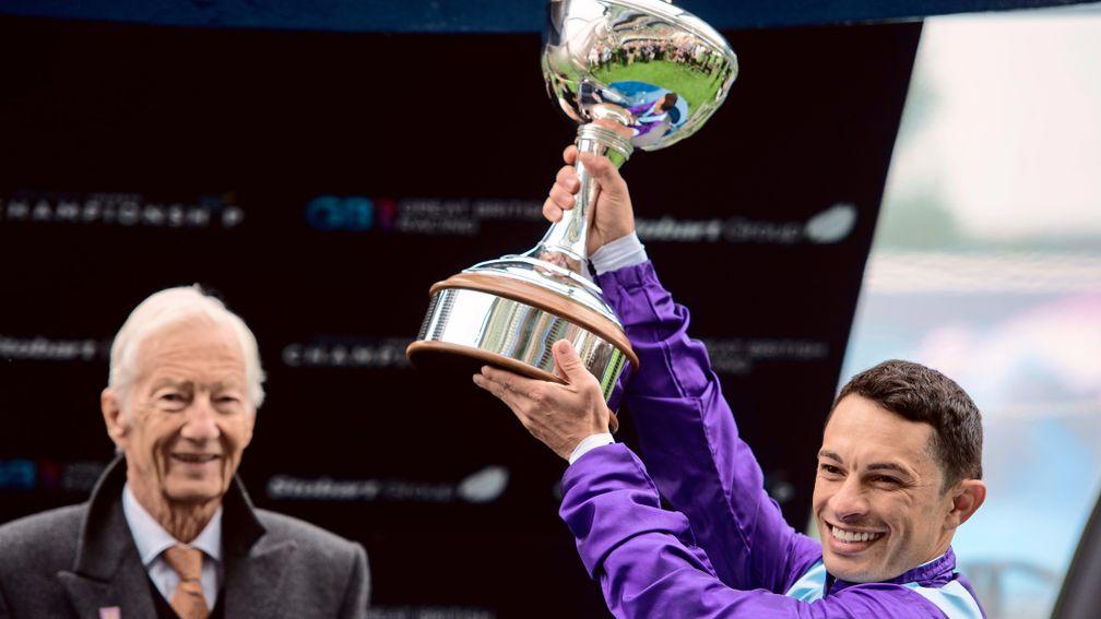 Silvestre de Sousa lifts the champion jockey trophy after winning the title in 2015