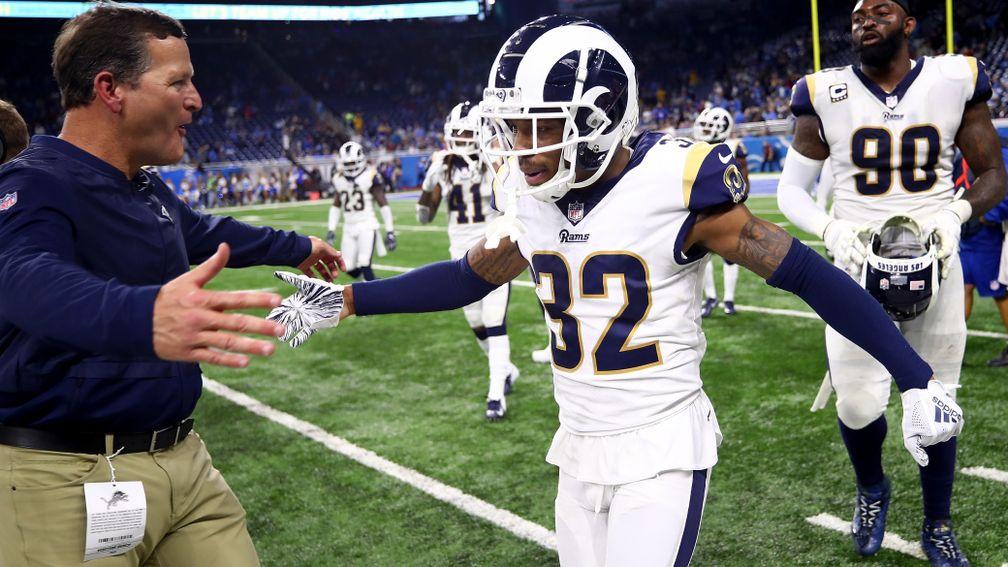 Troy Hill of the LA Rams celebrates on the sidelines after intercepting a Detroit pass