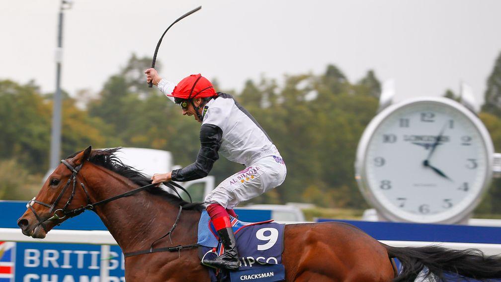 Frankie Dettori raises his whip in triumph passing the post in the Champion Stakes
