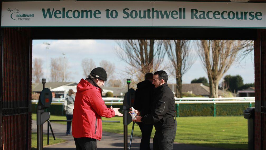 A racegoer sanitises their hands as they arrive at Southwell on Monday