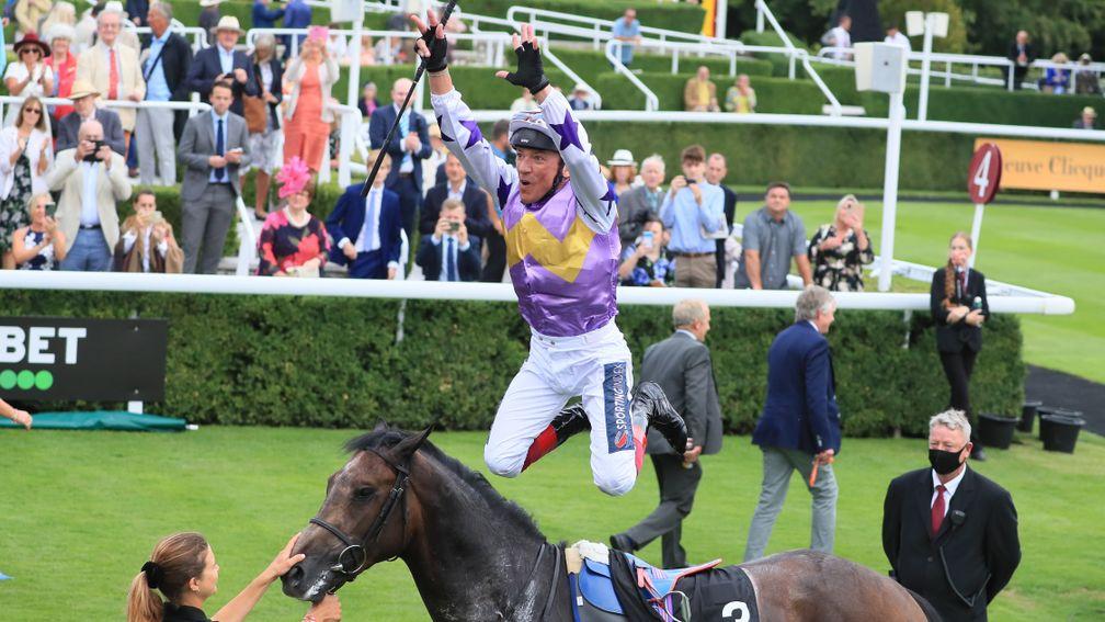 Frankie Dettori performs a flying dismount from Angel Bleu after the race