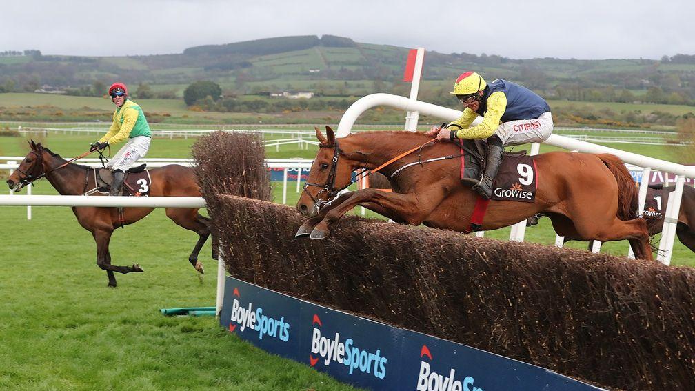 The Storyteller and Davy Russell jump the last on the way to victory with the stranded Finian's Oscar in the background