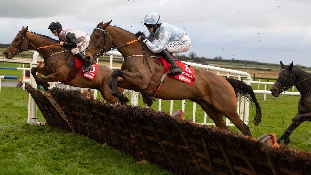 Teahupoo (left) and Honeysuckle jump a hurdle during the Hatton's Grace at Fairyhouse