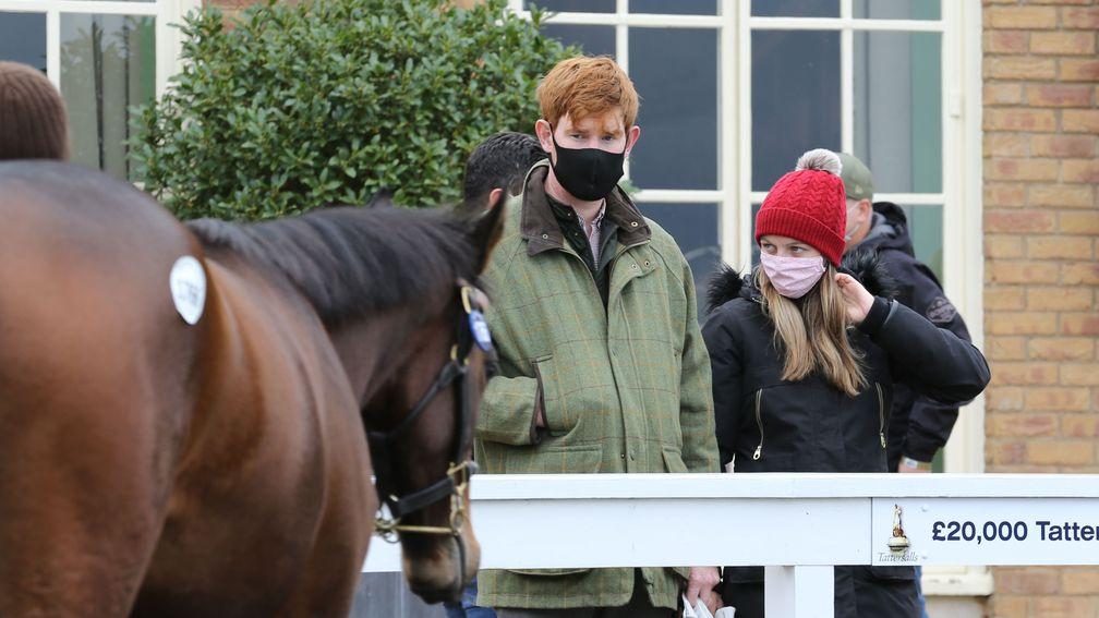 Conor Quirke and Kathryn Birch observe a yearling in the Tattersalls parade ring