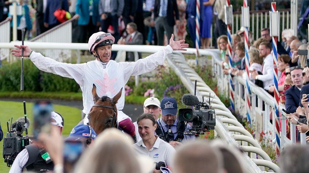 Frankie Dettori soak in the cheers of the crowd while being led back in on Absurde