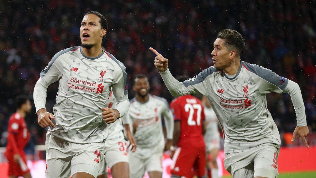 Liverpool's Virgil van Dijk celebrates with Roberto Firmino