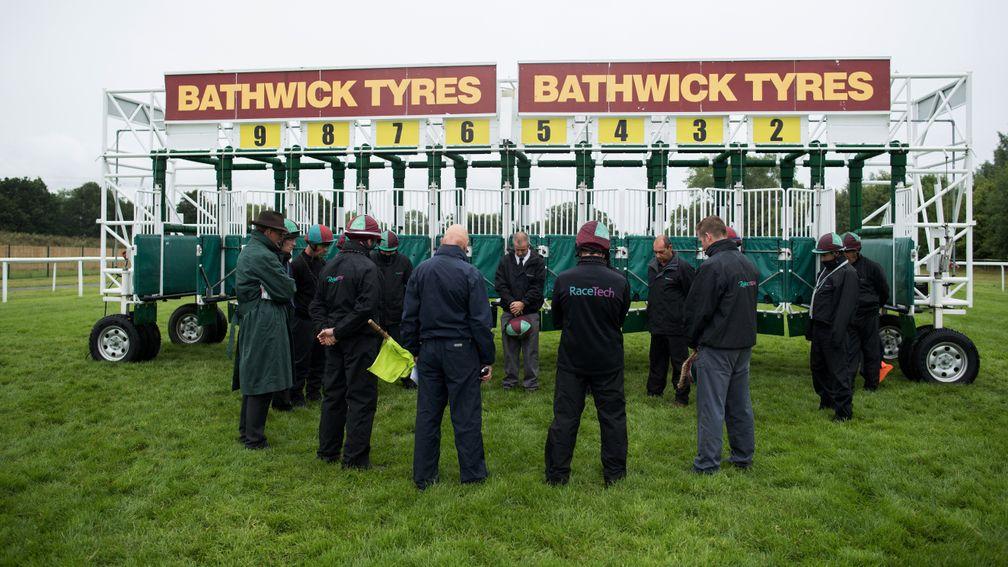 The team leader of the Racetech stalls handlers at Newbury, Arnie Jones (centre,black tie) leads a minutes silence in honour of the memory of Steve Yarborough, the stalls handler who died at Haydock on FridayNewbury 22.7.17 Pic: Edward Whitaker