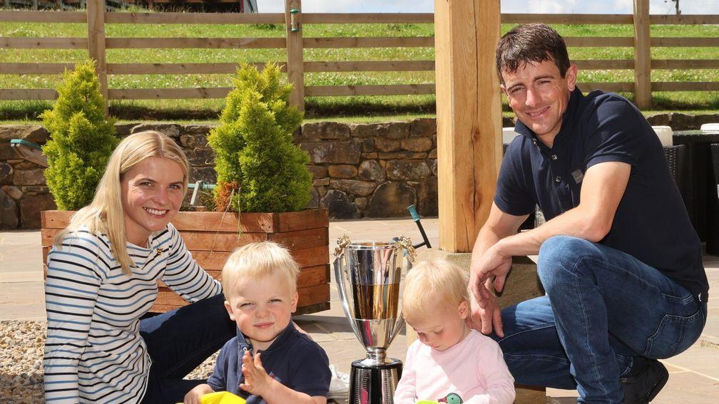 Brian Hughes at home with wife Lucy, son Rory and daughter Olivia as well as his 2019-20 jump jockeys' championship trophy