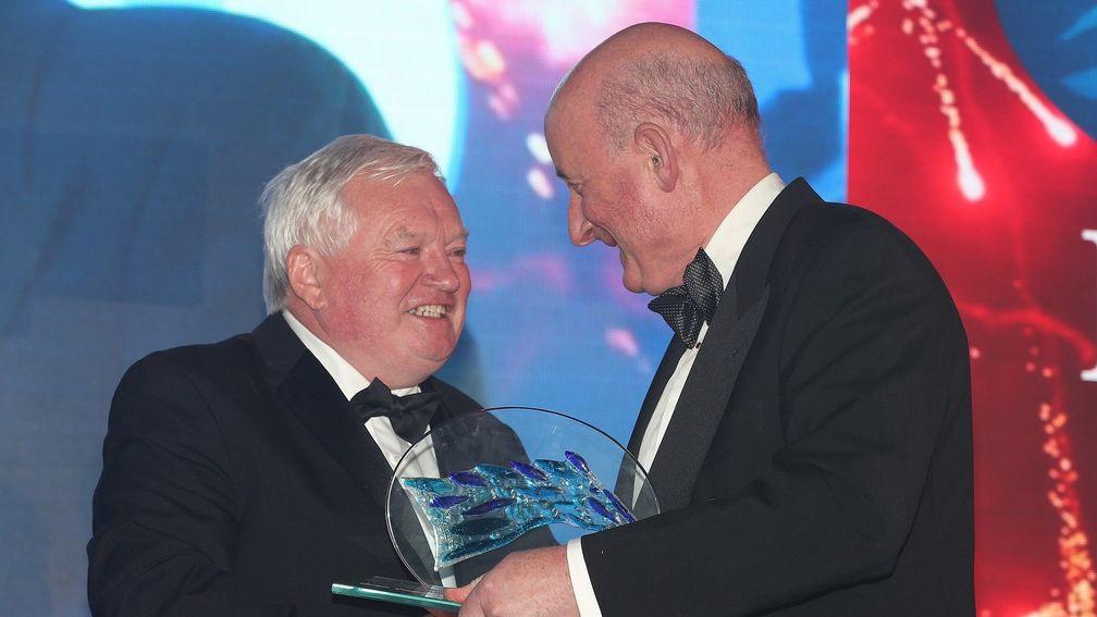 Gerry Dilger (left) receives the Wild Geese trophy at the ITBA awards