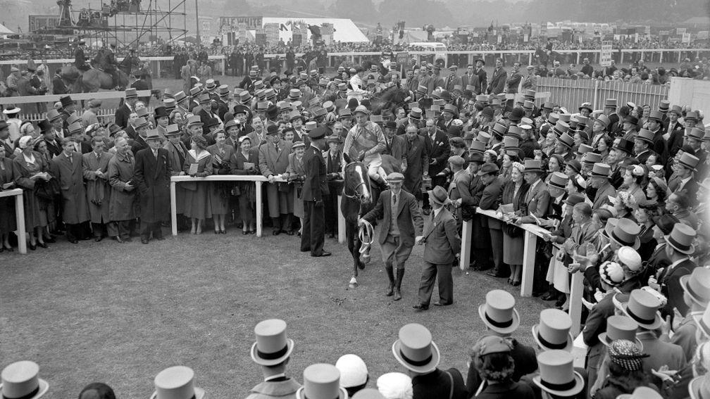 Lester Piggott and Never Say Die enter the winner's enclosure after winning the 1954 Derby