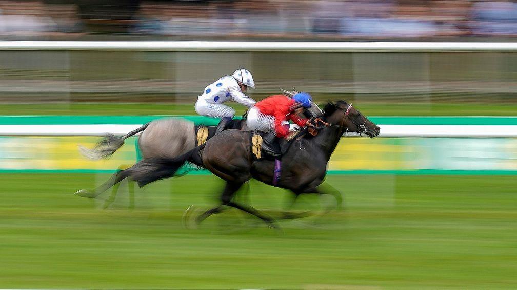 NEWMARKET, ENGLAND - JULY 09: David Probert riding Twilight Calls (red) win The Moet & Chandon Handicap at Newmarket Racecourse on July 09, 2021 in Newmarket, England. Due to the Coronavirus pandemic, only owners along with a limited number of the paying