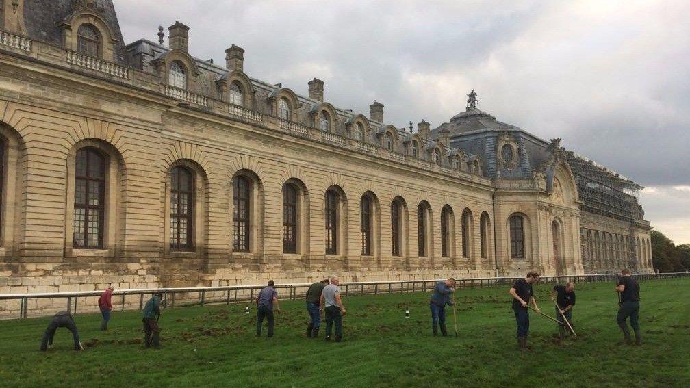 France Galop ground staff repair the damage caused overnight by a party of wild boar at Chantilly