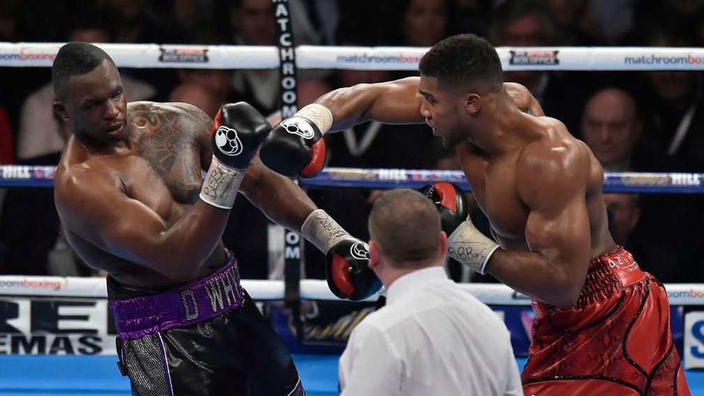 Anthony Joshua (right) throws a punch at Dillian Whyte during their fight in 2015