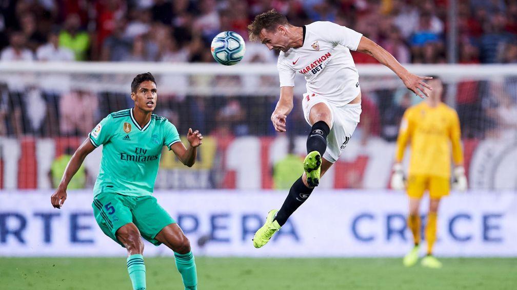 Sevilla's Luuk de Jong gets in a header against Real Madrid