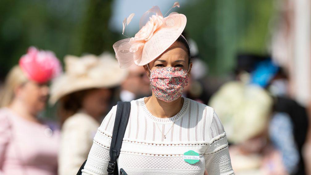 A racegoer arrives to Ascot for day one of the royal meeting