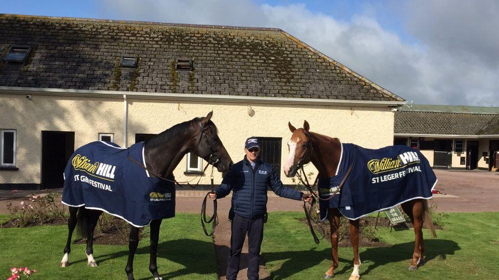Aidan O'Brien poses with St Leger candidates Sir Dragonet (left) and Il Paradiso
