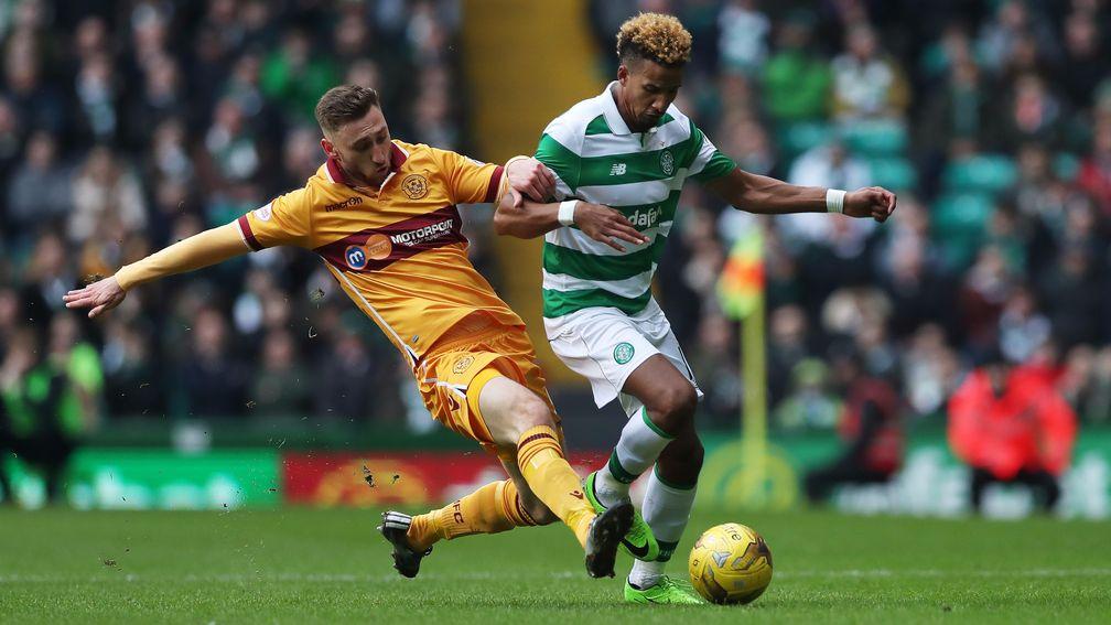 Louis Moult of Motherwell vies with Scott Sinclair of Celtic