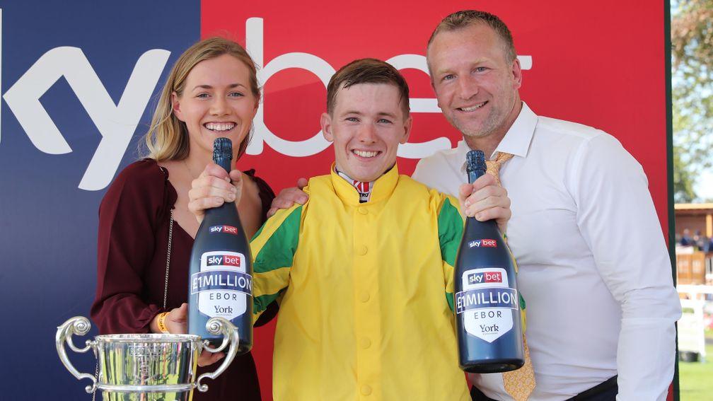 Colin Keane (middle) prepares to pop bottles in celebration of Mustajeer's victory alongside Kerri Lyons (left) and owner David Spratt
