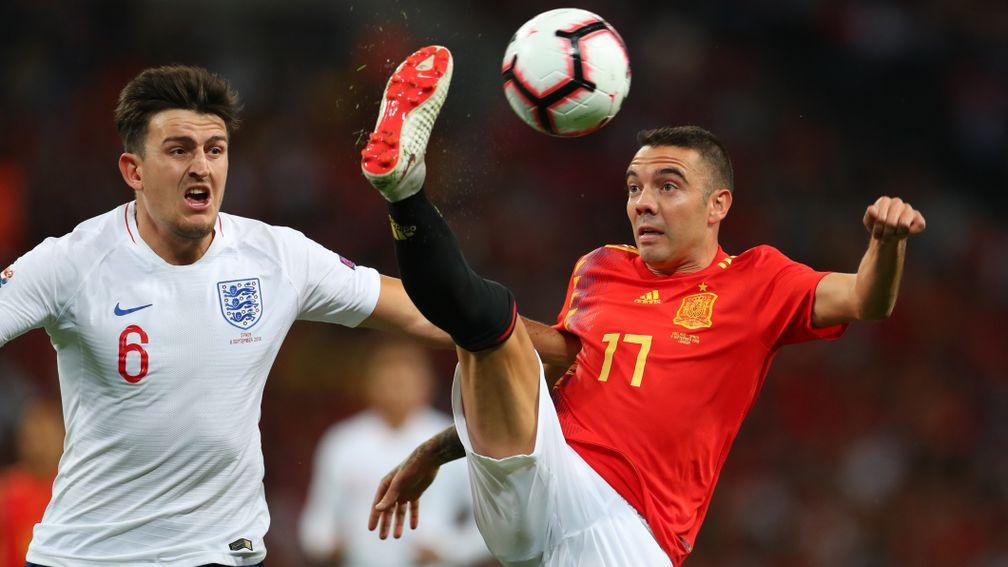 Harry Maguire of England and Iago Aspas of Spain in action