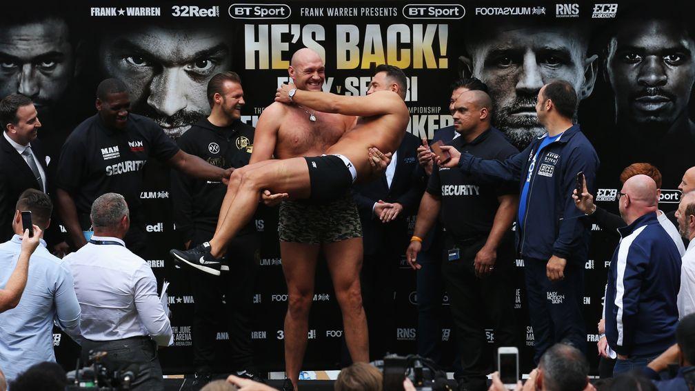 Tyson Fury holds opponent Sefer Seferi like a baby during the weigh-in
