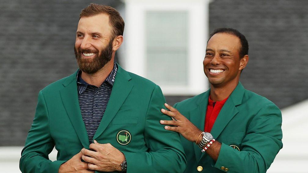 Defending Masters champion Dustin Johnson receives his Green Jacket from Tiger Woods