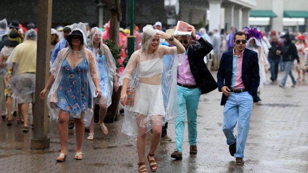 Racegoers in the rain: torrential downpours hit Churchill Downs on Kentucky Derby day