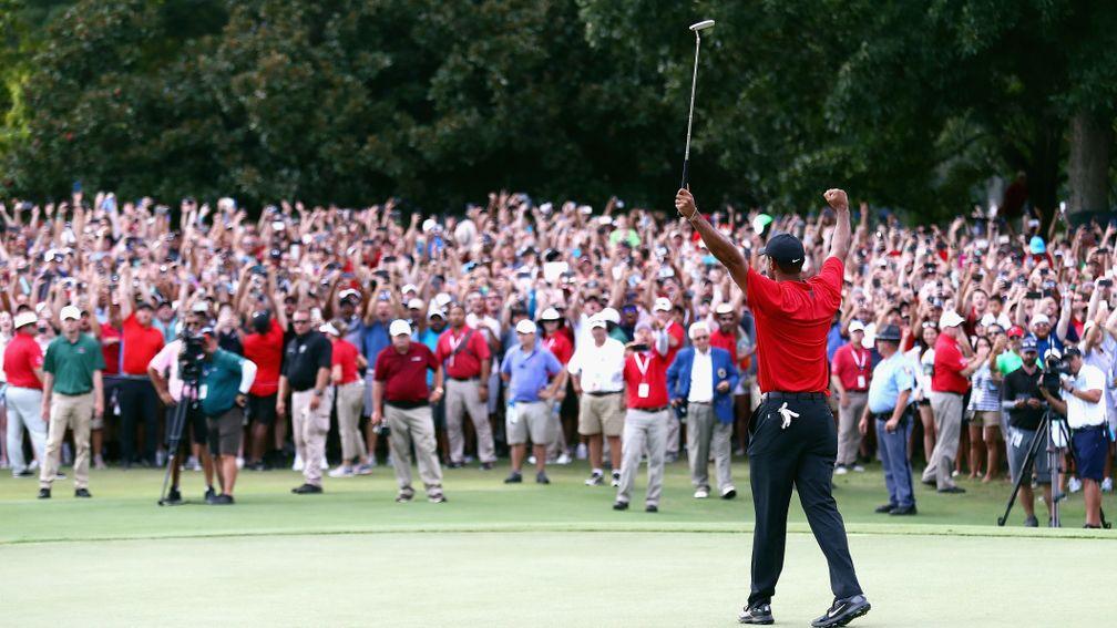 Tiger Woods celebrates sinking his par putt to win last year's Tour Championship