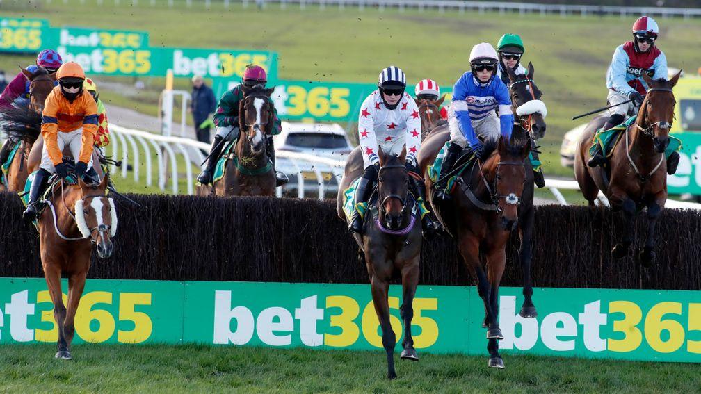 Aye Right and Callum Bewley (white silks) jumping alongside Cyrname in the bet365 Charlie Hall Chase at Wetherby