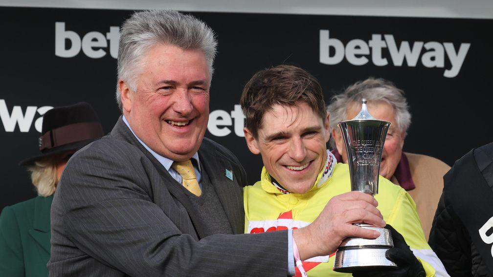 Politologue's trainer Paul Nicholls (left) and winning jockey Harry Skelton receive their prizes after the 2020 Champion Chase