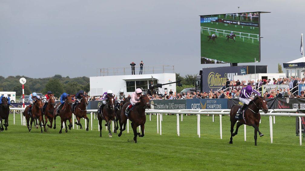 Kew Gardens (right) stays on strongly to hold the challenge of Lah Ti Dar in the St Leger at Doncaster