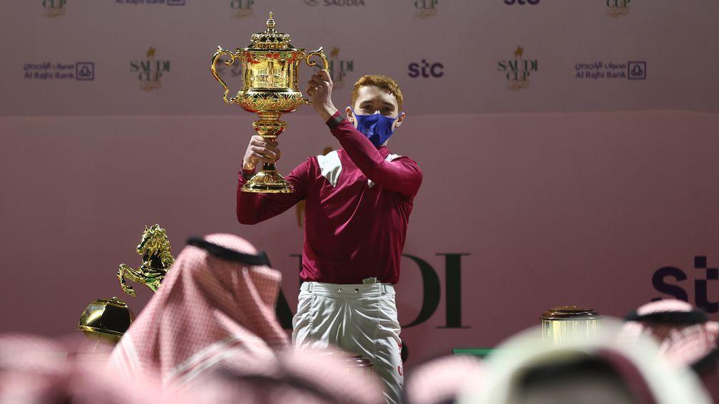 David Egan lifts the Saudi Cup after steering Mishriff to victory