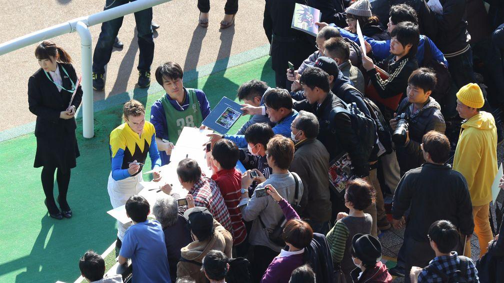 Ryan Moore signing autographs for fans after riding his fifth winner of the day at Tokyo on Saturday