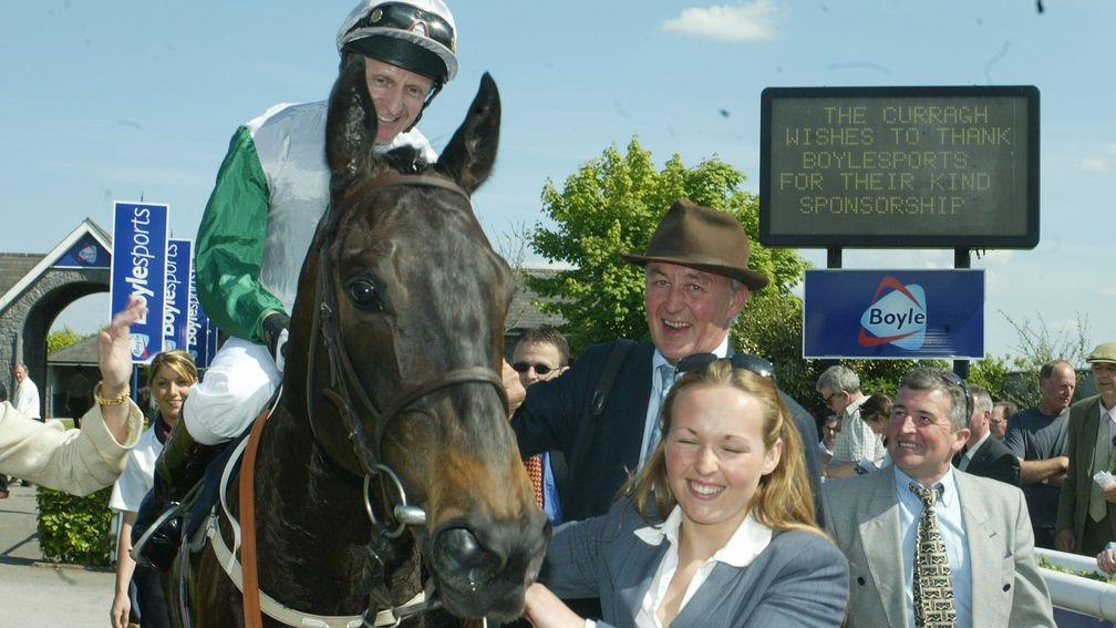 The Duke of Roxburghe (wearing a hat) with Attraction after her Irish Guineas success in 2004