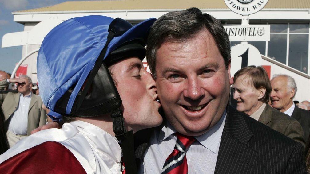 Eric McNamara gets a smacker from winning rider Paddy Flood after the trainer's Ponmeoath had recorded back-to-back wins in the Kerry National in 2008