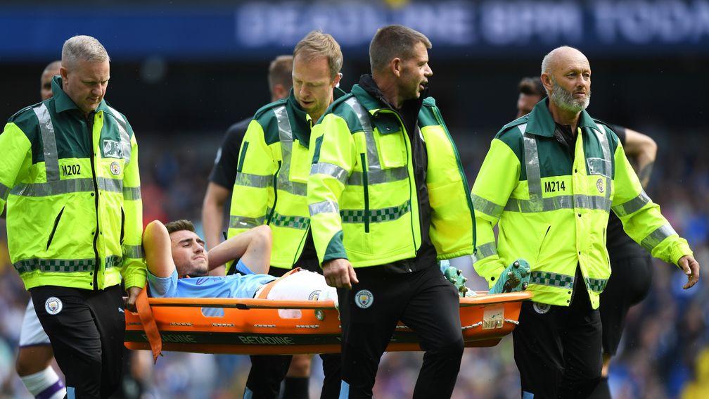 Aymeric Laporte of Manchester City is stretchered off against Brighton