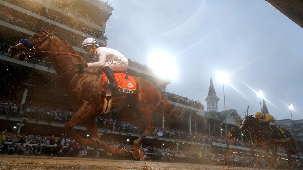 Justify (Mike Smith) claims the 144th Kentucky Derby beneath the lights and the Twin Spires at a murky Churchill Downs