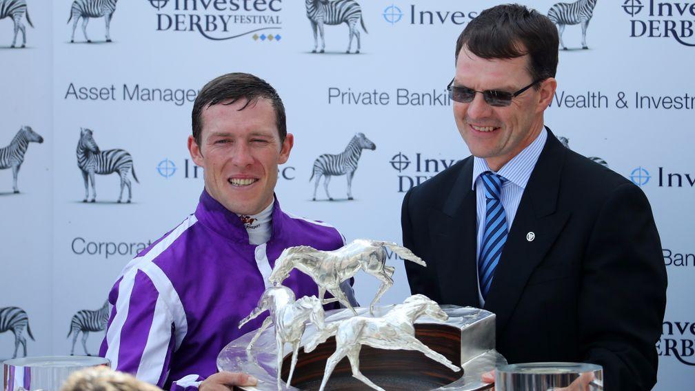 Padraig Beggy (left) with the Investec Derby trophy alongside winning trainer Aidan O'Brien