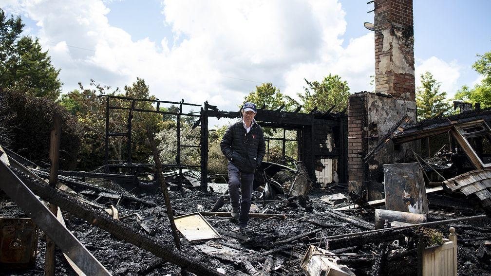 Trainer Jamie Osborne surveys the remains of the fire that devasted a bungalow at his Old Malthouse stables in Upper Lambourn