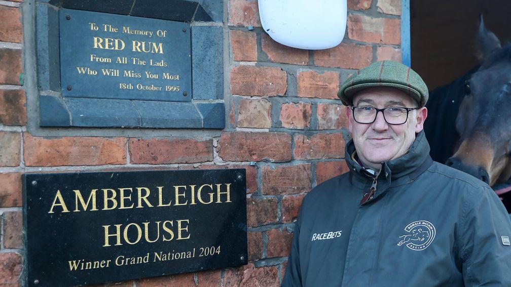 Donald McCain next to plaques of Grand National heroes Red Rum and Amberleigh House